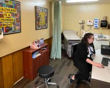Dr. Meisner sits at her desk in the clinic.